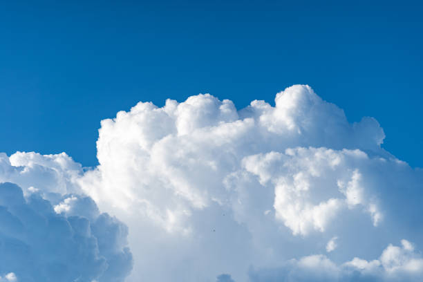 istock Blue sky white cumulus clouds before storm in summer cast shadow 1181716584