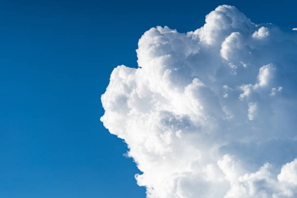 istock Blue sky white cumulus clouds before storm in summer cast shadow 1181716587