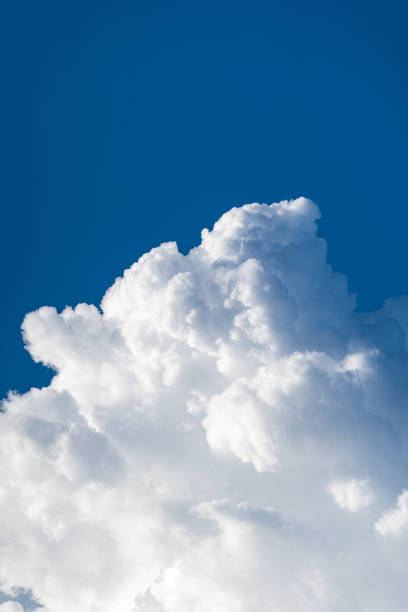 istock Blue sky white cumulus clouds before storm in summer cast shadow 1181716590