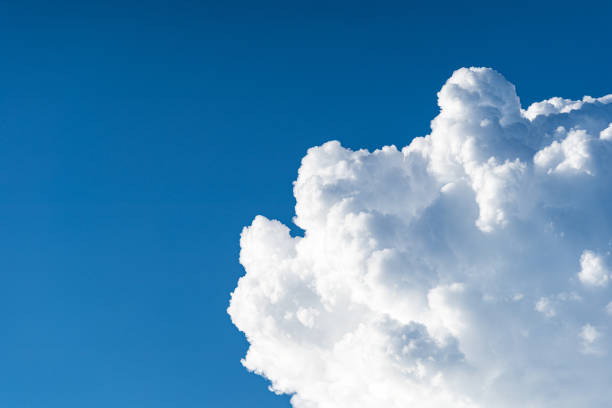 istock Blue sky white cumulus clouds before storm in summer cast shadow 1181716596