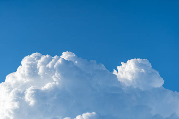 istock Blue sky white cumulus clouds before storm in summer cast shadow 1181716608