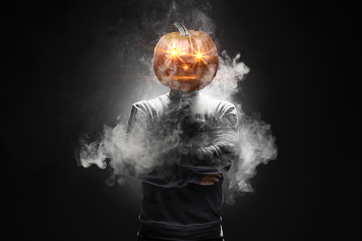 Man with the head of a pumpkin.Happy Halloween Concept.