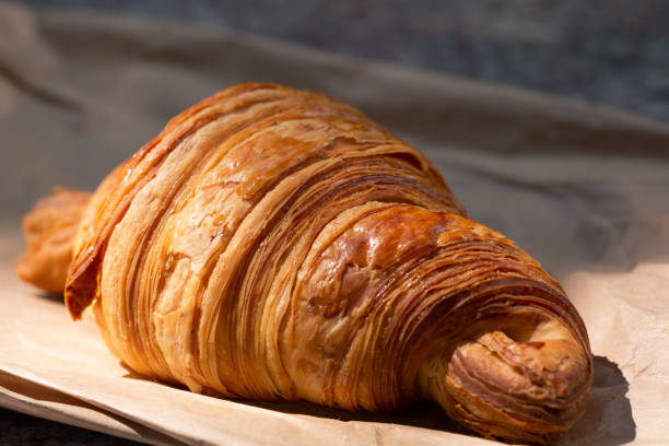 istock Flakey Croissant on Paper Bag 1181719048