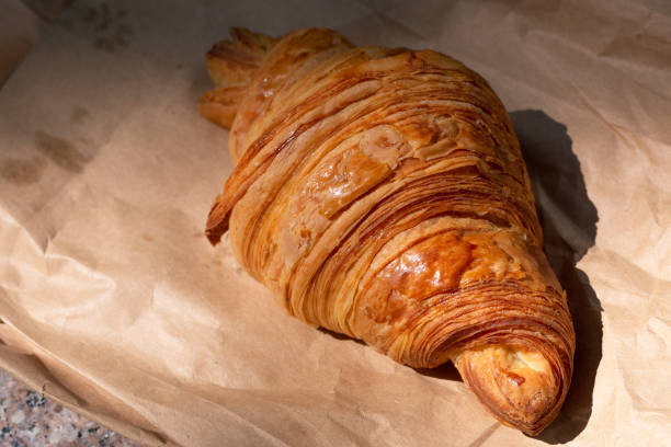 istock Flakey Croissant on Paper Bag 1181719067