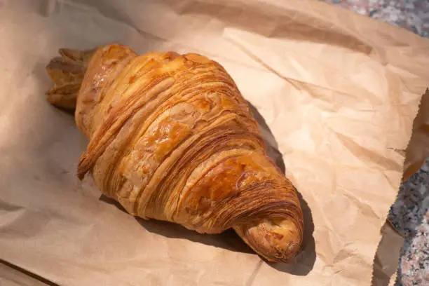 Photo of Flakey Croissant on Paper Bag