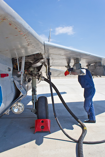 Refueling of military aircraft in airport. Preparations for flight.