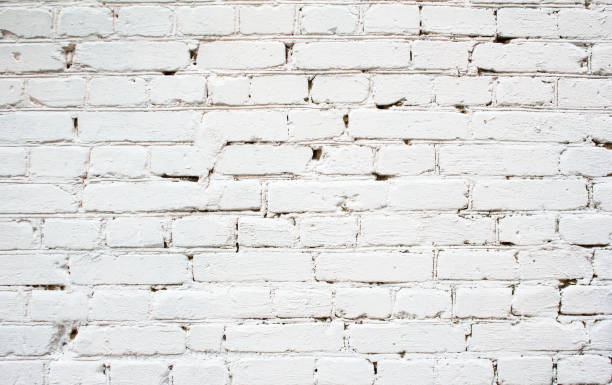 istock Old white dirty weathered brick wall texture background. 1181720289