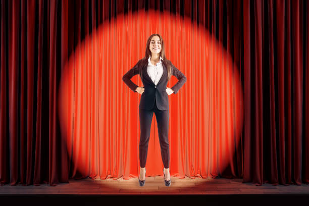 istock Attractive businesswoman on red stage 1181720362