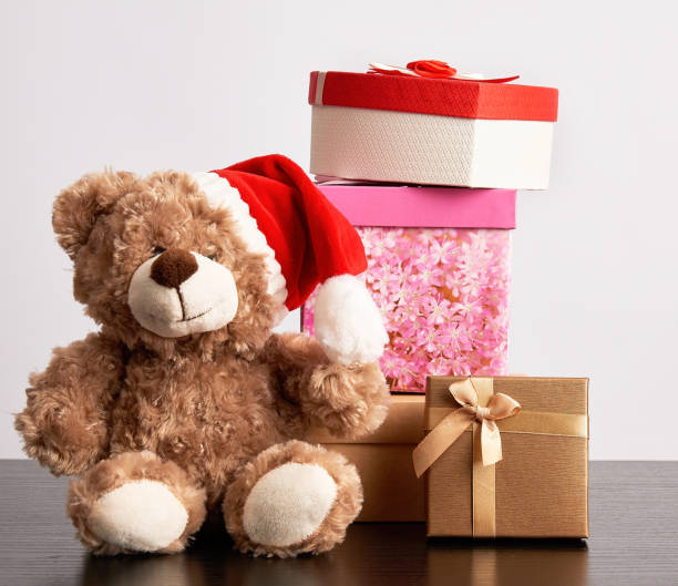 istock brown teddy bear and a stack of various cardboard boxes for gifts 1181724722