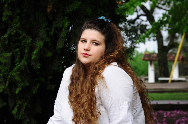 istock young woman with curls 1181727420