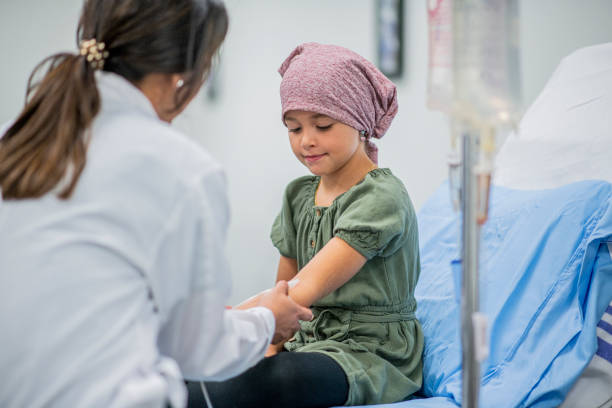 Little Girl Receiving Chemotherapy Treatment stock photo A little girl receiving chemotherapy treatment intravenously from her female Doctor hospital depression sadness bed stock pictures, royalty-free photos & images