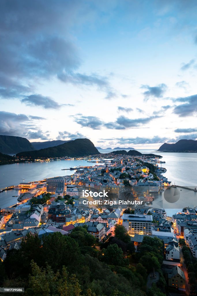City lights - Alesund, Norway (vertical) View of Alesund from Fjellstua. Viewpoint on top of the mount Aksla. City of Ålesund in Norway is beautifully situated on several islands on the coast of Sunnmøre, and is the gateway to some of the world's most famous fjords and natural attractions. Alesund Stock Photo