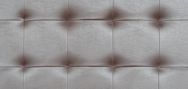 istock Light black luxury upholstery sofa texture background concept for clean gray vintage leather furniture pattern wallpaper, closeup interior elegant armchair mattress surface detail, real tuft material. 1181729599