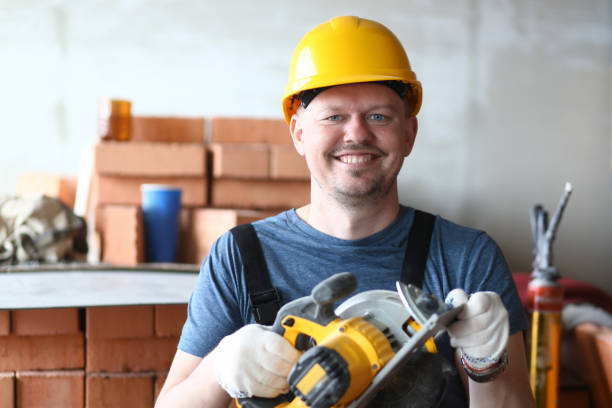 Smart builder with power equipment Portrait of skilled specialist holding electric saw carefully and joyfully. Happy man using new and modern tool in order to make work easier. Building concept stacker stock pictures, royalty-free photos & images