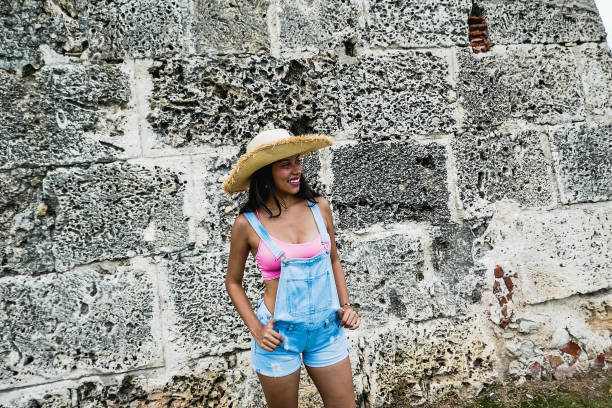 istock girl posing with hat outside 1181735375