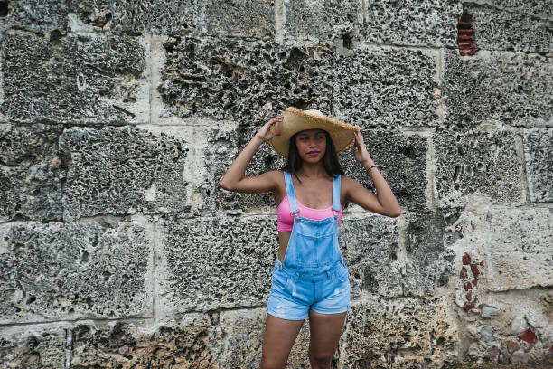 istock girl posing with hat outside 1181736054