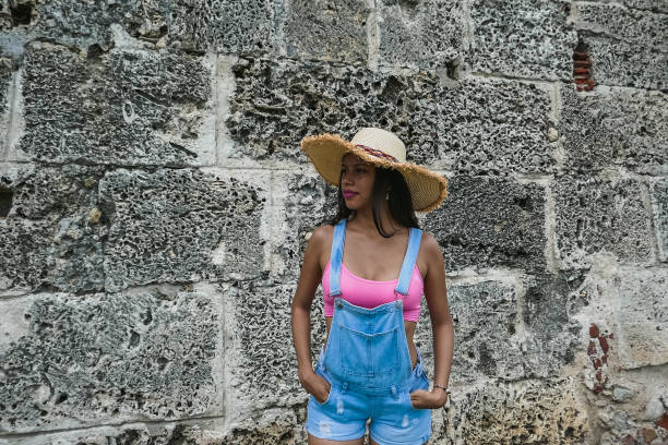 istock girl posing with hat outside 1181736130