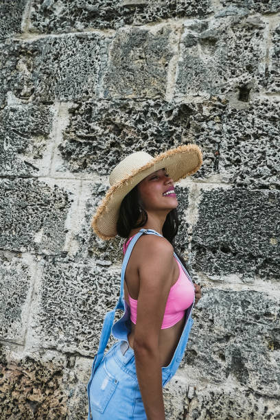 istock girl posing with hat outside 1181736193