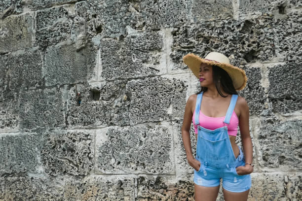 istock girl posing with hat outside 1181736243