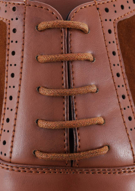 istock Brown leather men's shoe with brown laces close-up 1181736384