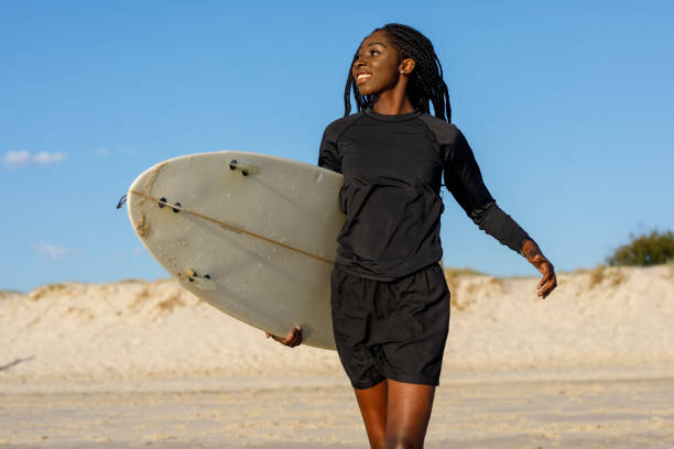 istock Female Surfer Going For A Surf At Australian Beach With Perfect Blue Sky 1181739242