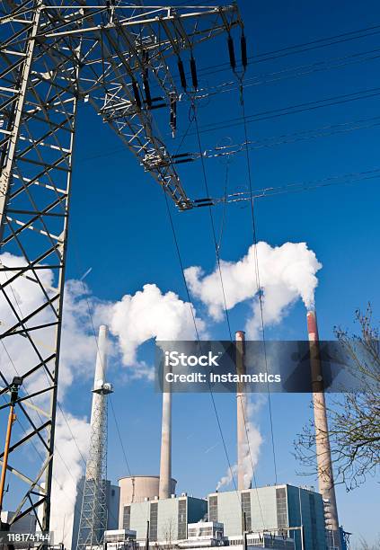 Power Plant With Steaming Chimneys And Dak Blue Sky Stock Photo - Download Image Now