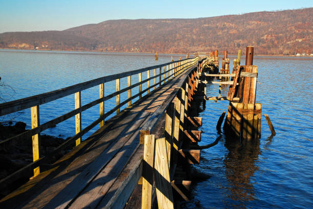 A pier extends into the river stock photo