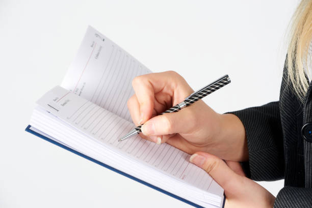 istock Woman writing in organizer 1181751872