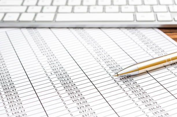 istock Spreadsheet with financial data, pen and computer keyboard on the table. Business concept. 1181756764