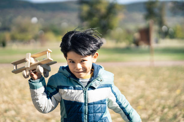 istock Little boy playing with wooden toy and running 1181761299