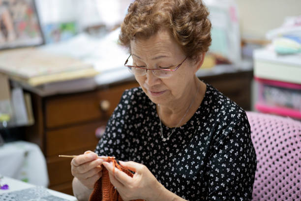 istock Elderly woman enjoying hobby knitting 1181763268