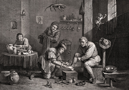 Vintage illustration shows a country surgeon at work, treating the foot of a patient. As the surgeon bends down to apply a leech to the man's foot, his wife looks on anxiously. The workroom is filled with flasks and vessels, and a stuffed lizard specimen hangs from the ceiling above. The surgeon's young assistant works at a nearby table, mixing ingredients in a bowl.