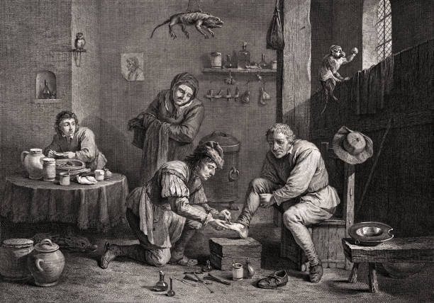 The Country Surgeon at Work Vintage illustration shows a country surgeon at work, treating the foot of a patient. As the surgeon bends down to apply a leech to the man's foot, his wife looks on anxiously. The workroom is filled with flasks and vessels, and a stuffed lizard specimen hangs from the ceiling above. The surgeon's young assistant works at a nearby table, mixing ingredients in a bowl. 18th century style stock illustrations