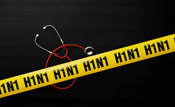 istock Red Stethoscope and Quarantine Tape Barrier over Black Background 1181764262