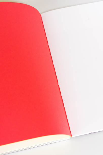 istock opened blank  book at white red yellow design paper background. 1181766812