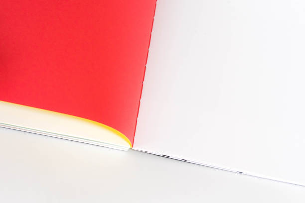 istock opened blank  book at white red yellow design paper background. 1181766819