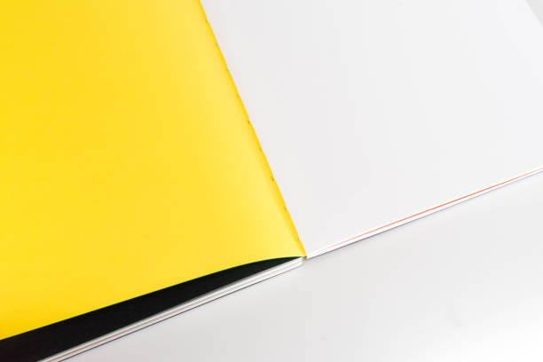 istock opened blank  book at white black yellow design paper background. 1181766824