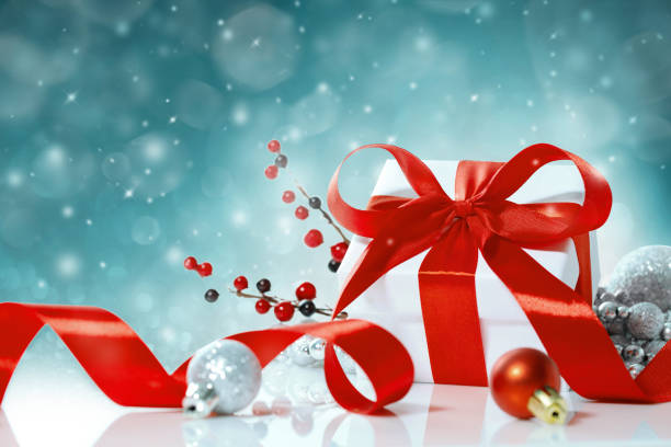 istock Christmas gift box with red bow on the background lights 1181774072