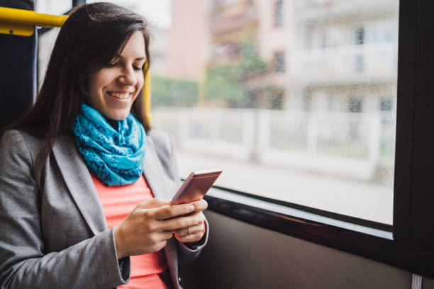istock Woman using phone on a city bus 1181777660