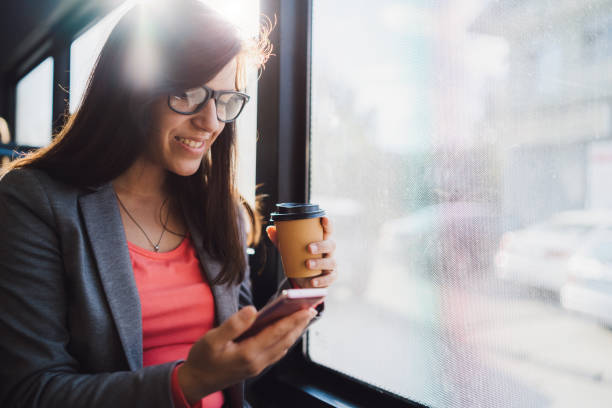 istock Woman using phone on a city bus 1181777679
