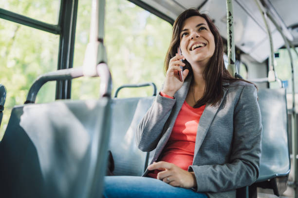 istock Woman using phone on a city bus 1181777694