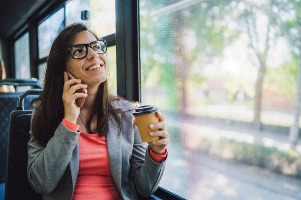 istock Woman using phone on a city bus 1181777737