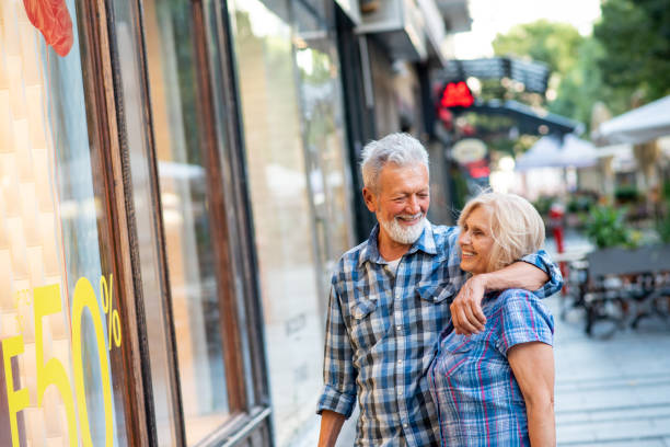istock Happy senior couple hugging during shopping 1181780878