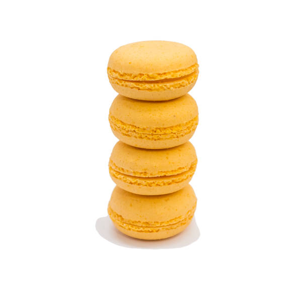 istock Creative layout of yellow macaroons on isolated white background 1181781210