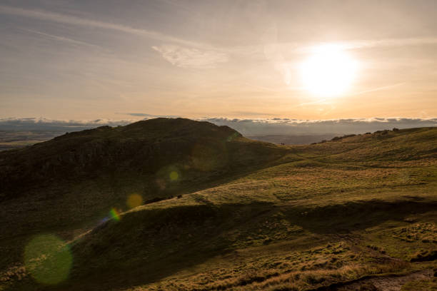 istock People standing on green grassy hill – Arthur’s Seat 1181781440