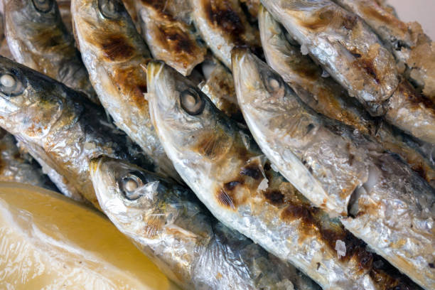 Grilled sardines fish on a plate.