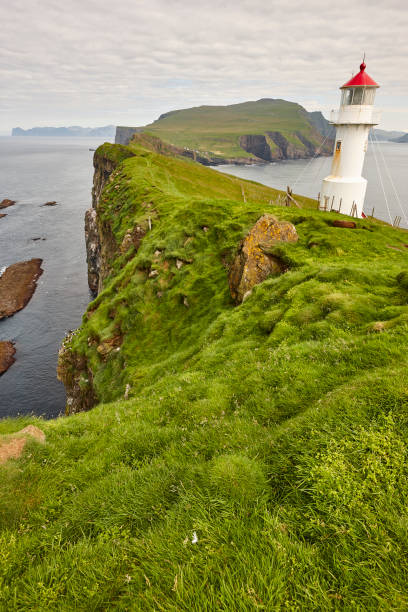 istock Mykines lighthouse and cliffs on Faroe islands. Hiking landmark 1181784268