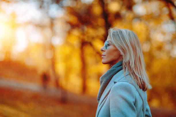 istock Young woman enjoying a sunny autumn day 1181784573