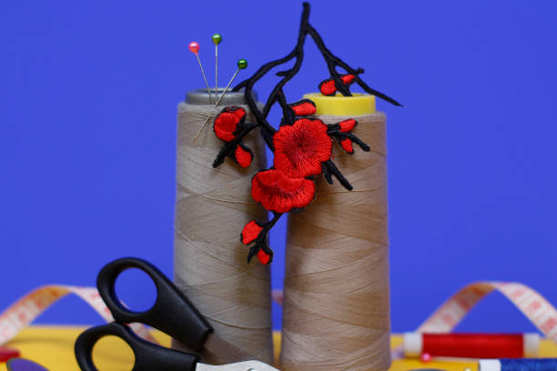 istock Two large spools of thread stand on a blue background. 1181784574