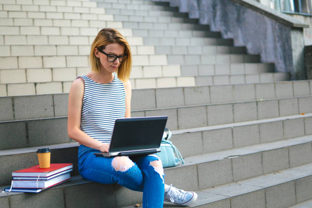 istock College woman using laptop 1181788096